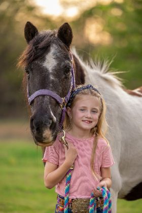 Young girl with her paint pony
