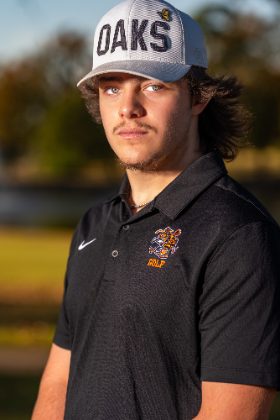 Senior portrait of a young man in a ball cap