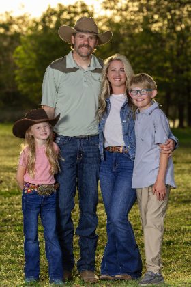 Western family of four in a field