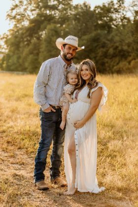 Maternity photo of a western couple with their daughter