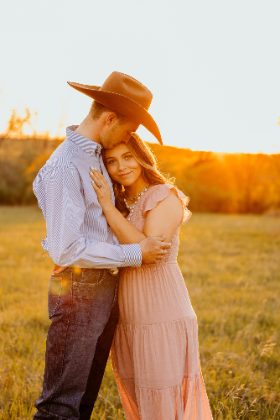 Western couple embracing at sunset