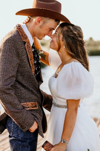 Western couple in cowboy hat touching foreheads